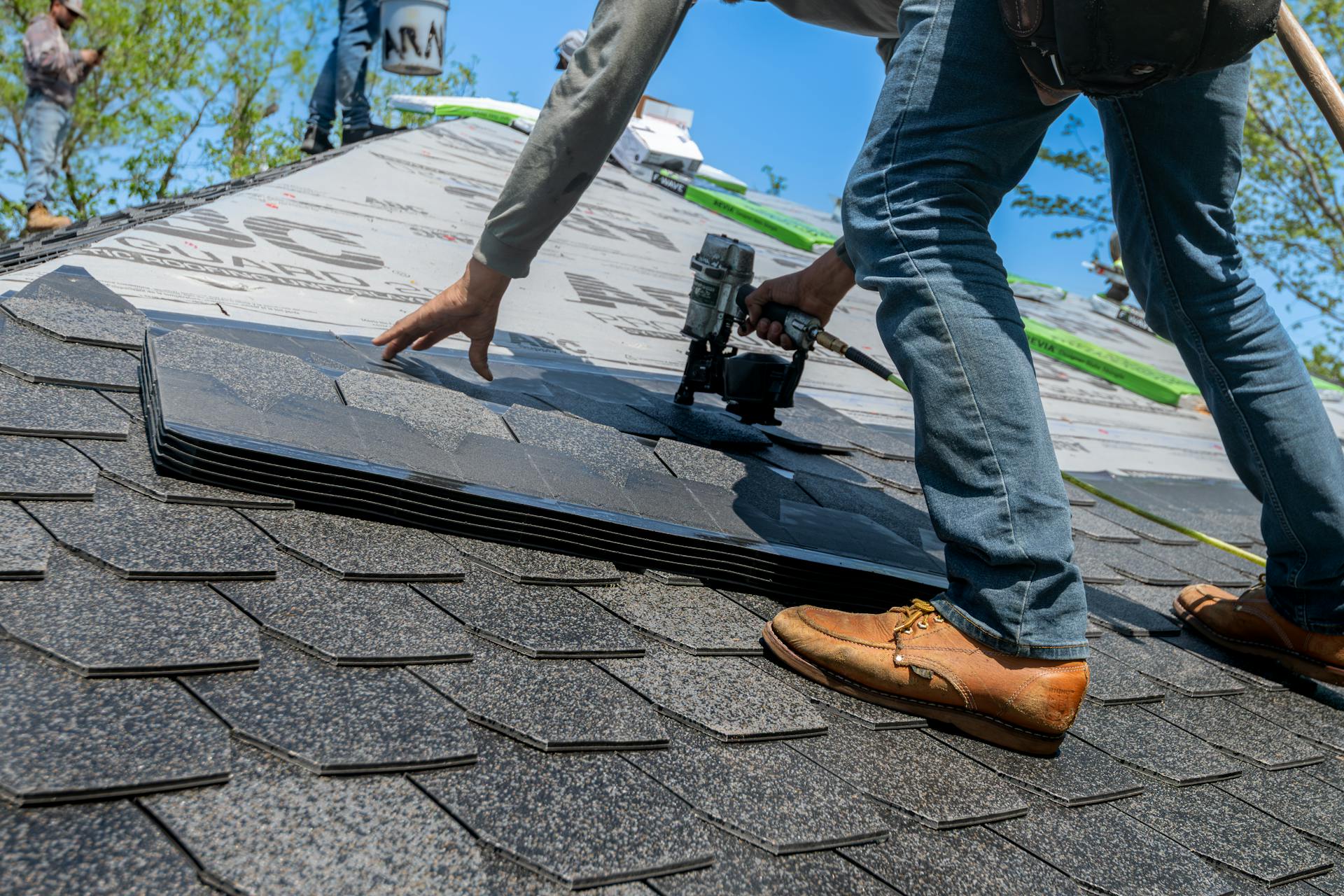 Professional roofer installing shingles on a Pittsburgh home